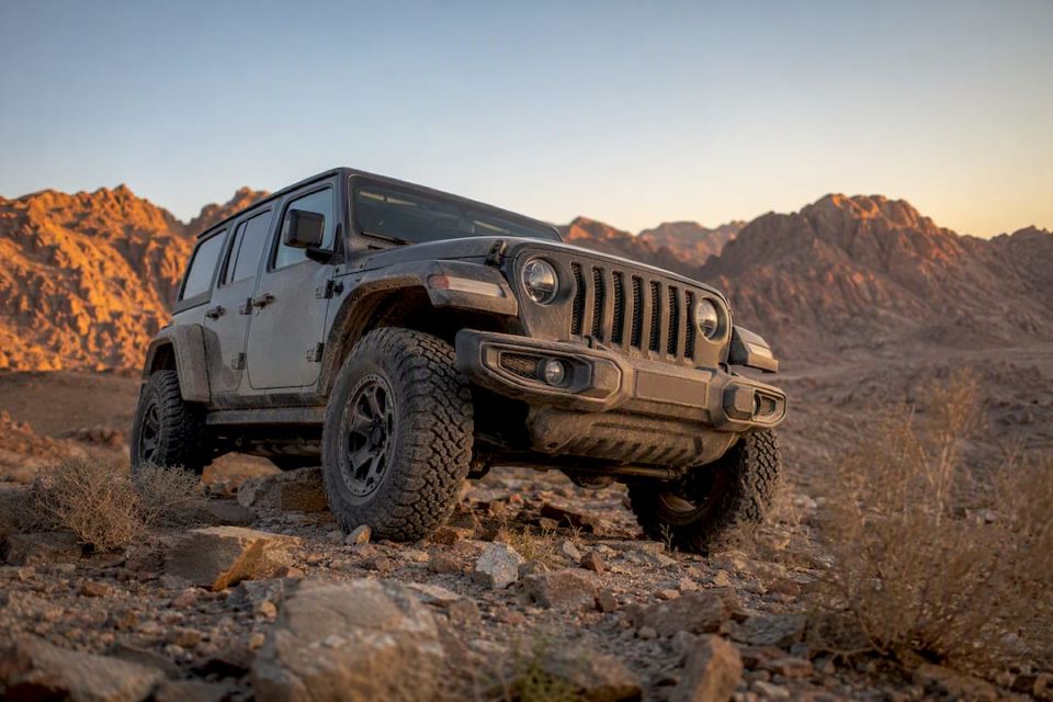 4x4-jeep parkerad i öknen nära bergen