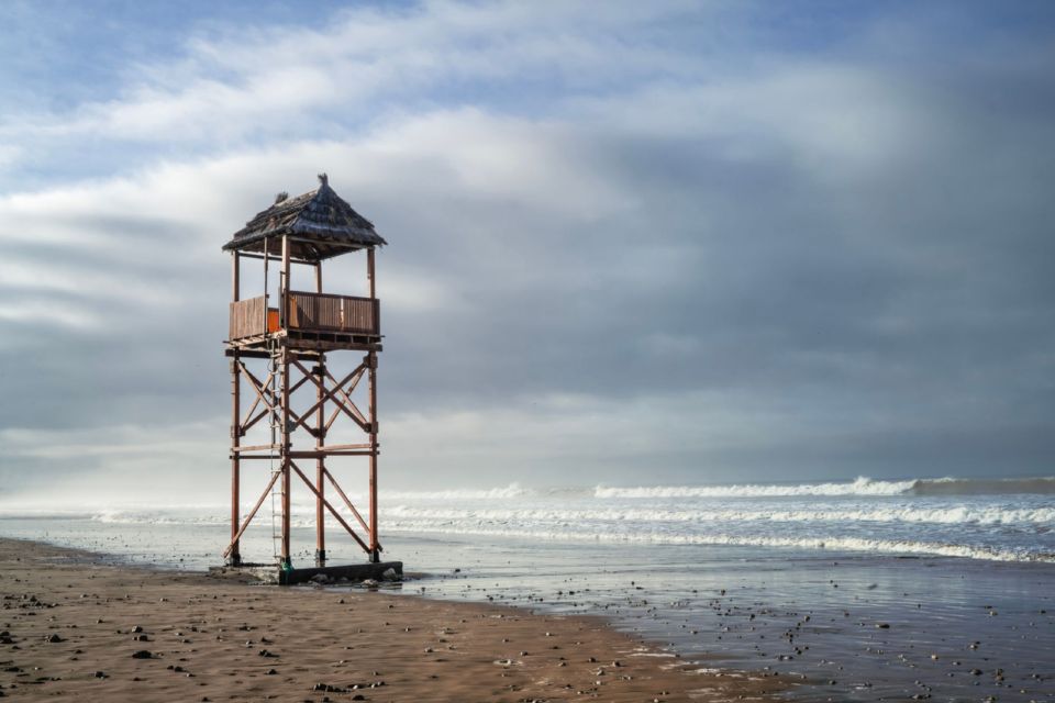 A wooden lifeguard tower stands on a quiet beach in Agadir, Morocco.