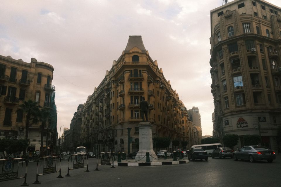 A historic street junction in central Cairo, lined with classic buildings and daytime traffic.