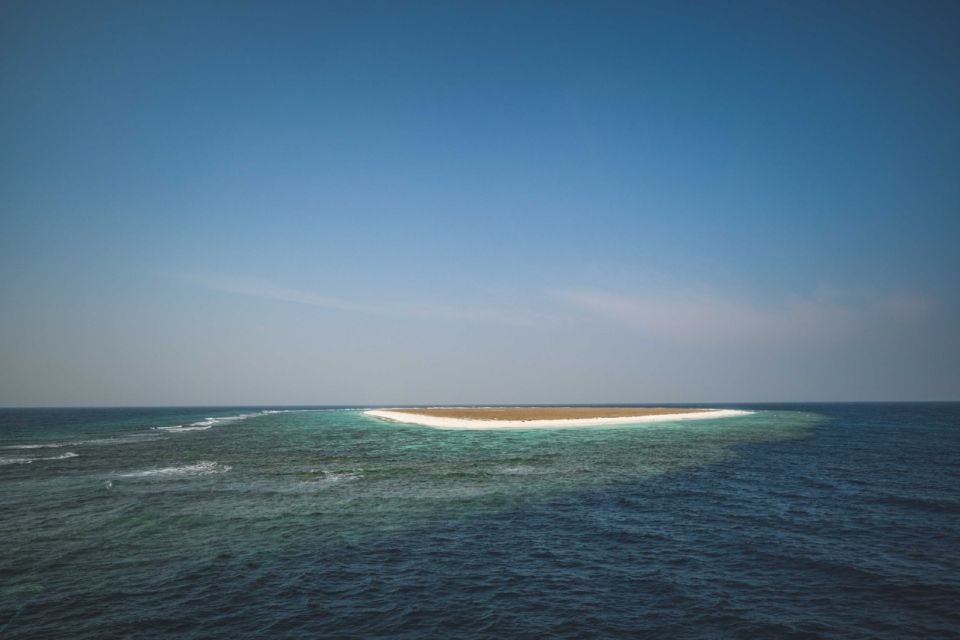 A sandy atoll near Tiran Island surrounded by turquoise shallows and deep blue sea